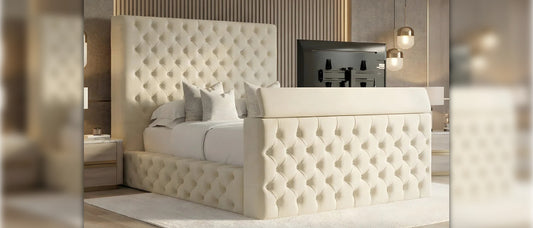 Cream Chesterfield TV bed frame with high buttoned headboard and upholstered footboard in a modern bedroom setting