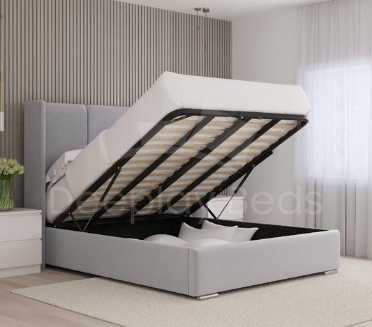Gray upholstered bed with open storage compartment in a bedroom setting.