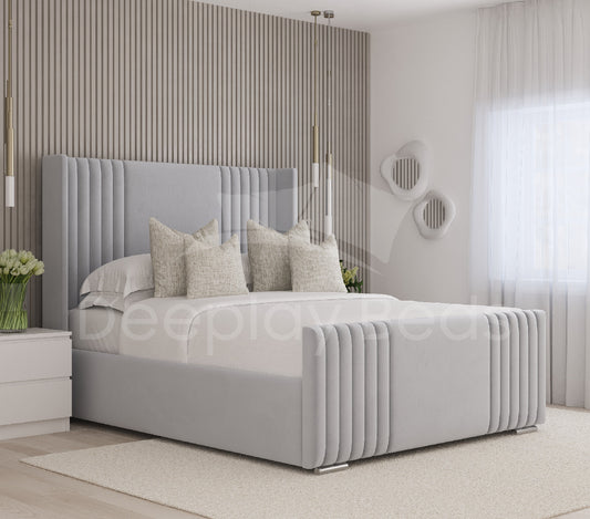 Manhattan Silver Wingback Panel Tall Headboard Ottoman Storage Bed Frame with sleek pleated design and spacious under-bed storage, perfect for modern luxury bedrooms.