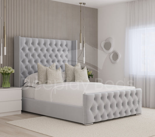 Gray tufted bed with white bedding in a modern bedroom setting.