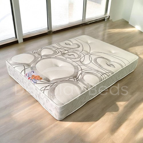 Mattress with decorative patterns on a wooden floor