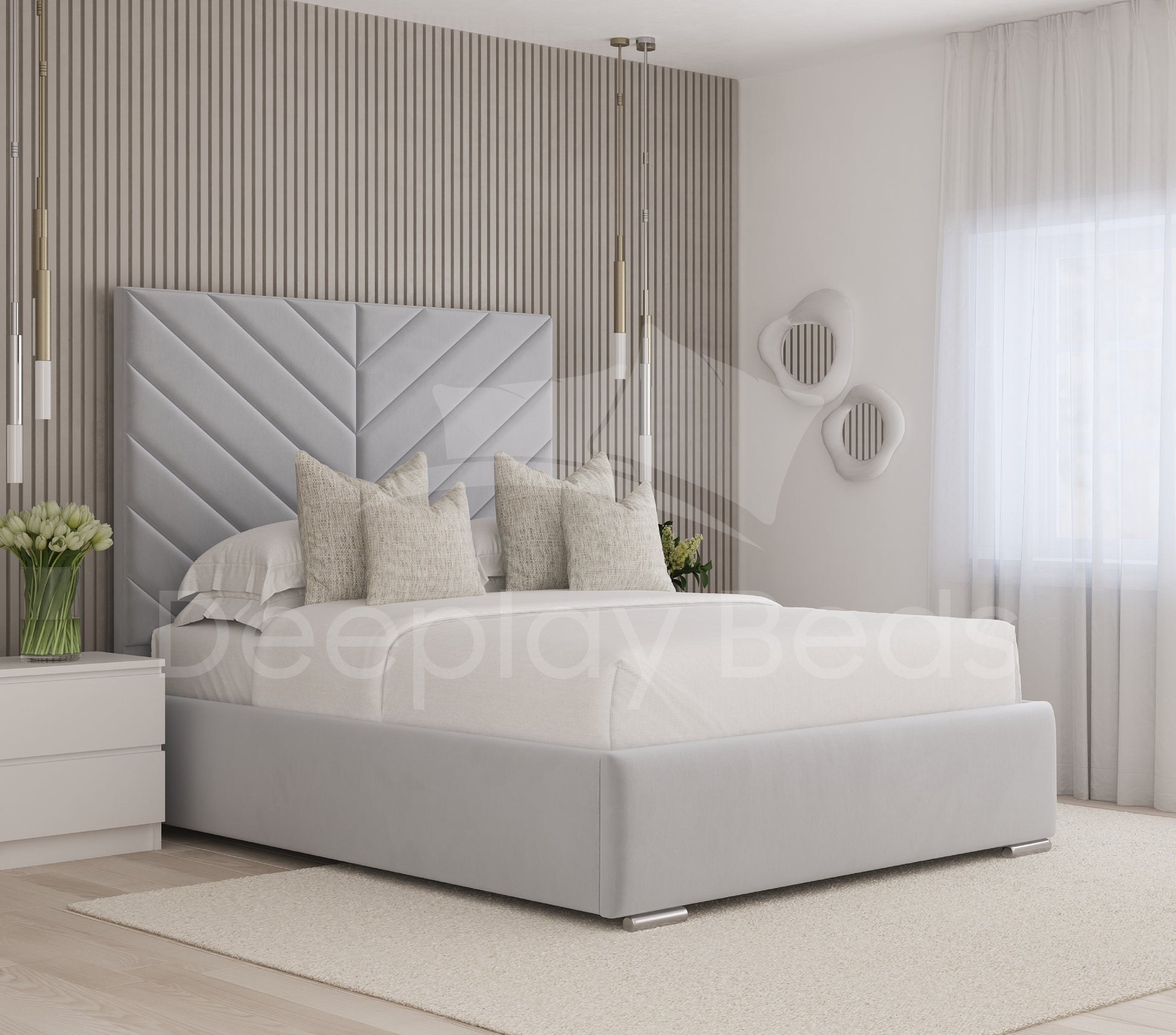 Gray upholstered bed in a modern bedroom setting with decorative pillows and a stylish headboard.