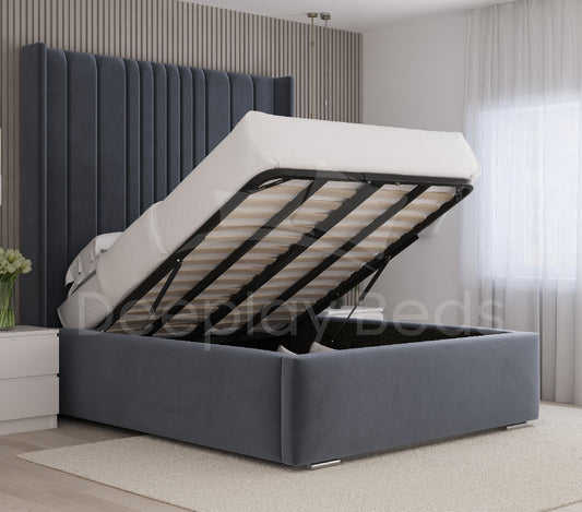 Chelsea blue wingback upholstered ottoman bed frame with lift-up storage base and tall headboard.