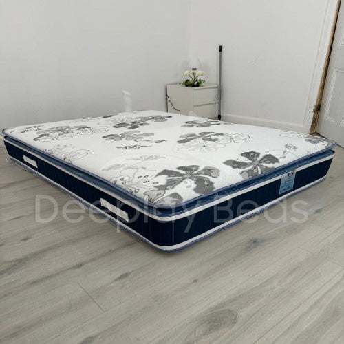 Mattress with floral pattern on a wooden floor, brand 'Delight Beds' visible