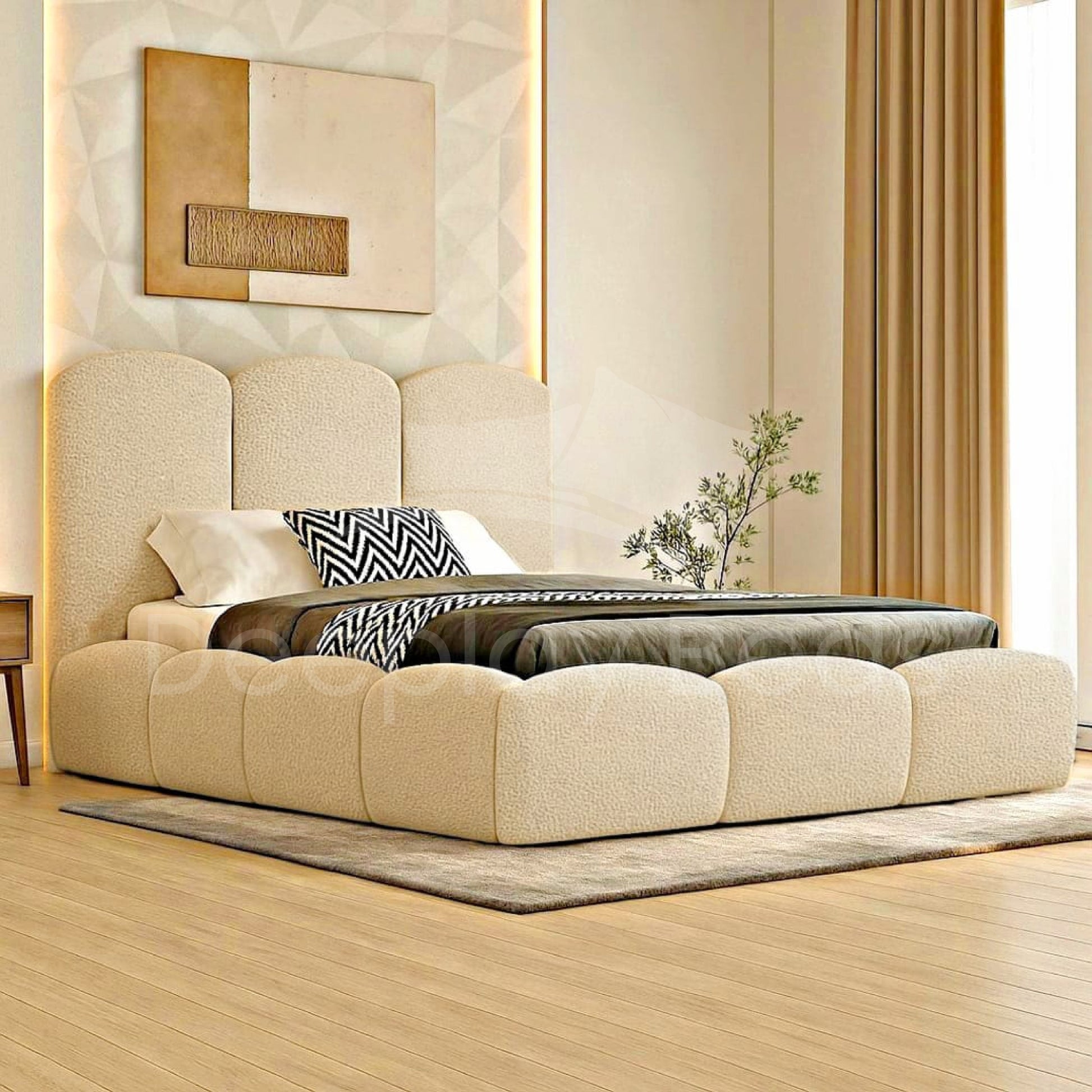 Beige upholstered bed in a modern bedroom with decorative elements.