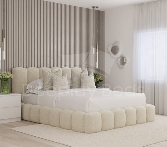 Modern bedroom with a beige upholstered bed and striped wall.