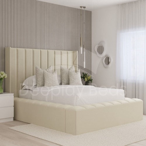 Beige upholstered bed in a modern bedroom with striped wall and white curtains.