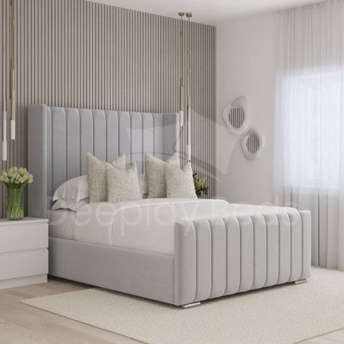 Gray upholstered bed in a modern bedroom with decorative pillows and nightstands.
