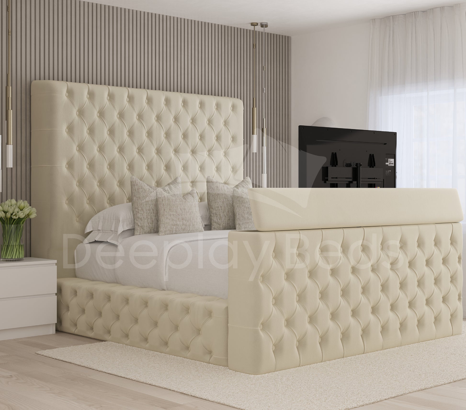 Beige tufted bed in a modern bedroom setting with a television in the background.